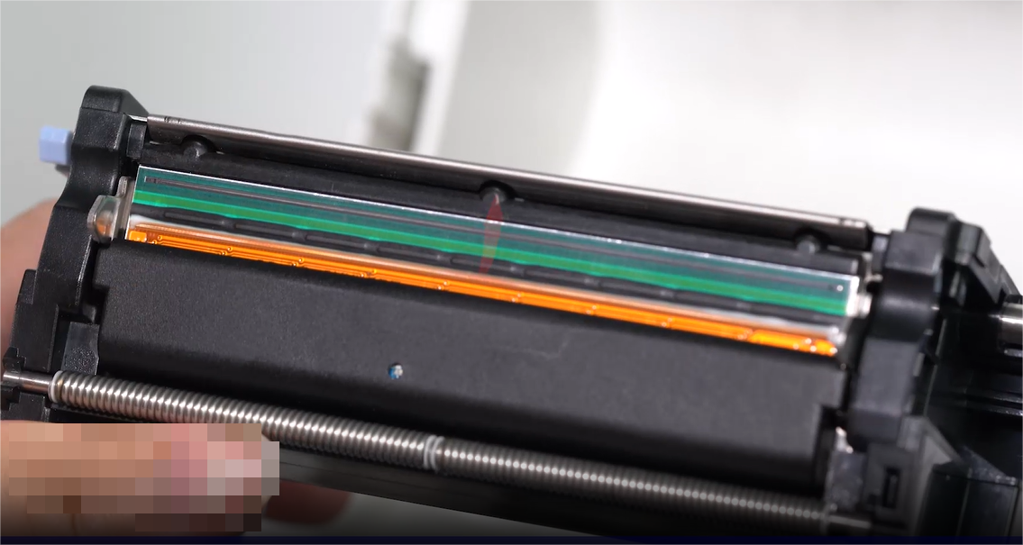 এ close-up of a person carefully cleaning an electronic component with a swab.